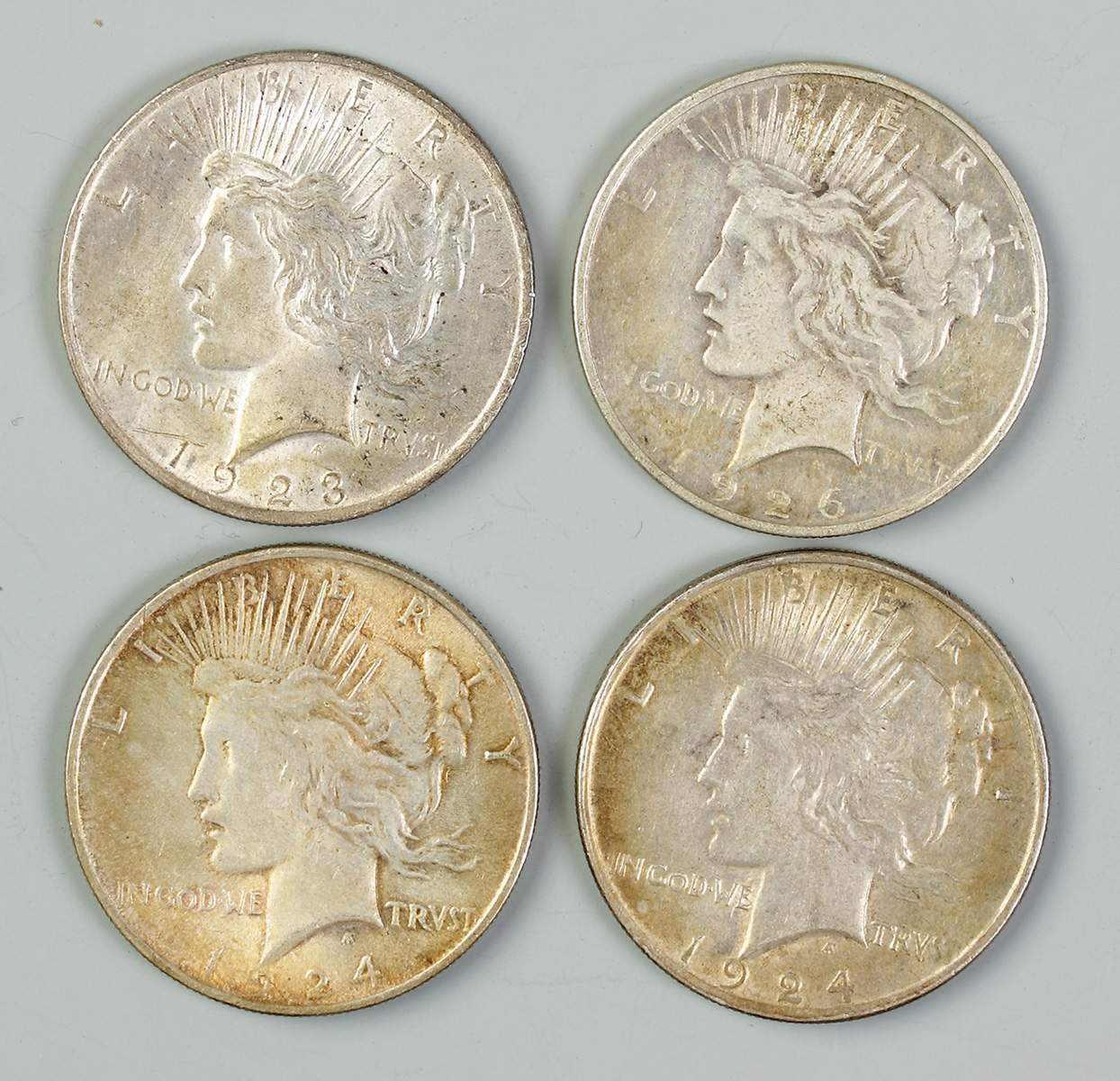 Four One Dollar Liberty Coins | Cottone Auctions