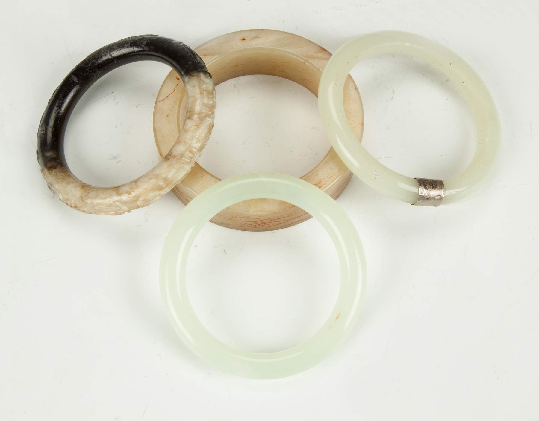 Four Chinese Jade Bracelets | Cottone Auctions